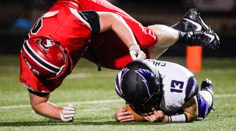 Madison’s Max Evans gets through for a sack on Cincinnati Hills Christian Academy quarterback Cole Fisher during their 50-6 win over Cincinnati Hills Christian Academy in their Division V, Region 20 football semifinal, Saturday, Nov. 10 at Lakota East High School in Liberty Township. NICK GRAHAM/STAFF