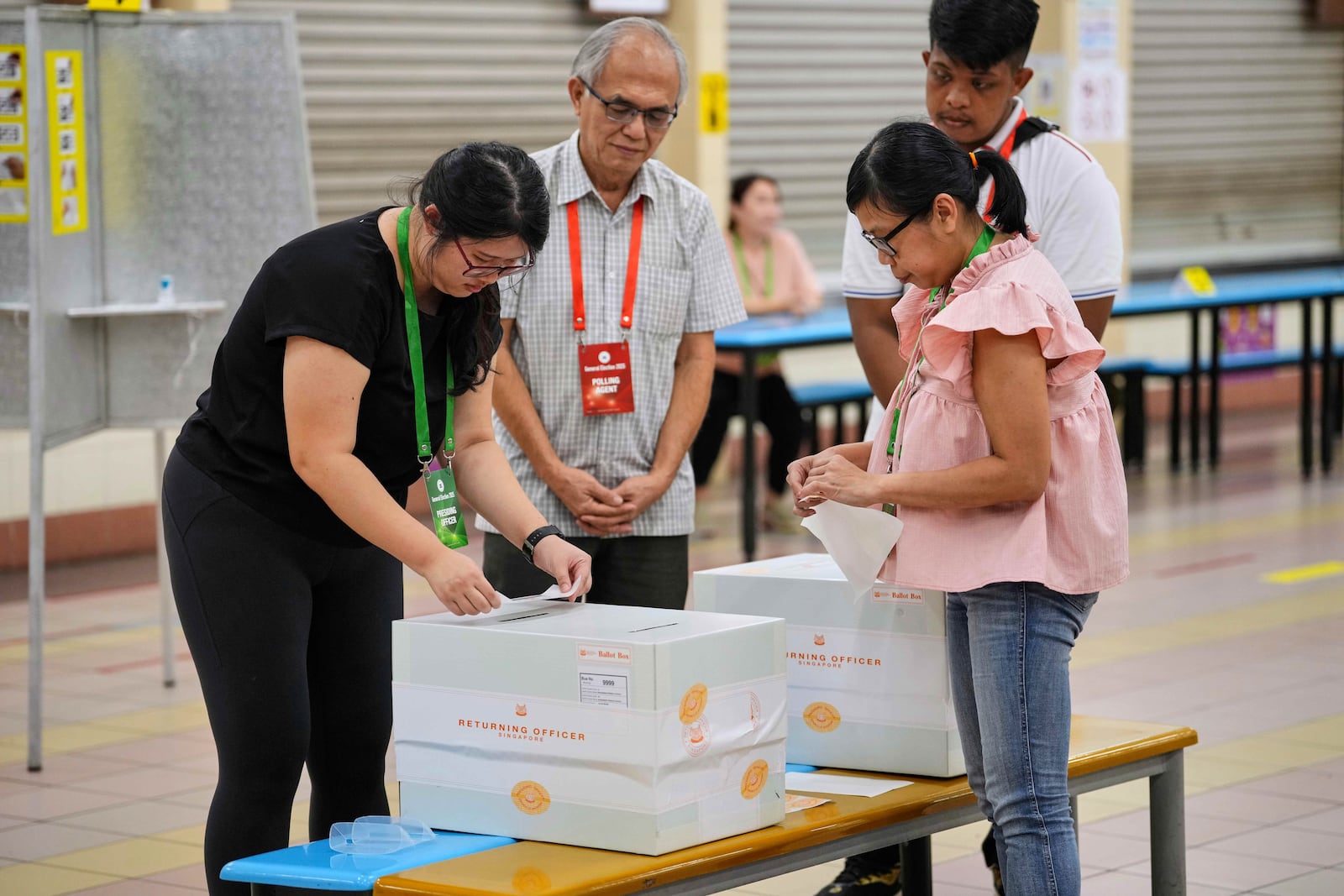 Officials at a polling station seal the ballot box after the voting closed in Singapore’s general election in Singapore, Saturday, May 3, 2025. (AP Photo/Vincent Thian)