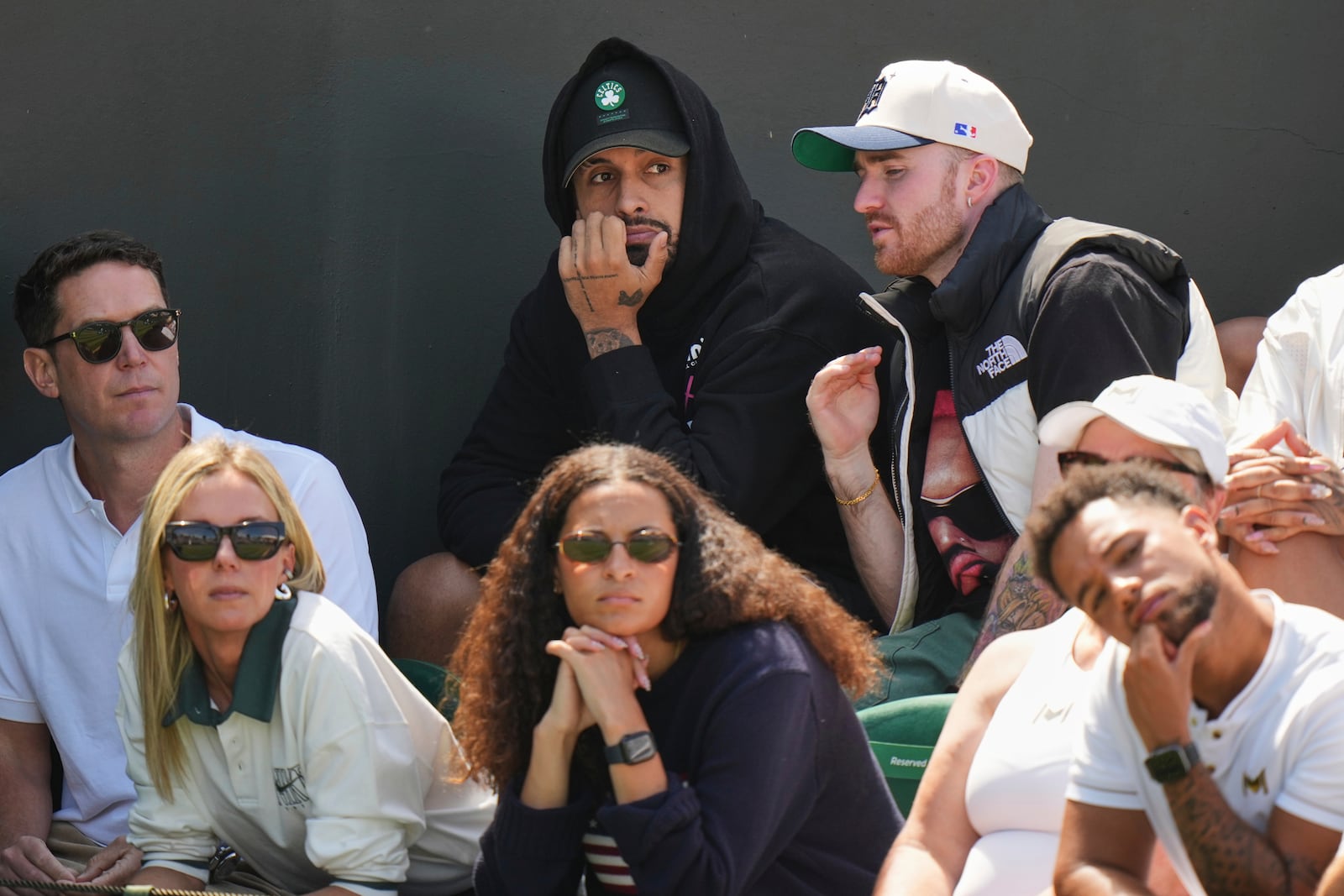 Australian tennis player Nick Kyrgios, top center, watches as Naomi Osaka of Japan plays Russia's Anastasia Pavlyuchenkova during a third round women's singles match at the Wimbledon Tennis Championships in London, Friday, July 4, 2025. (AP Photo/Alastair Grant)