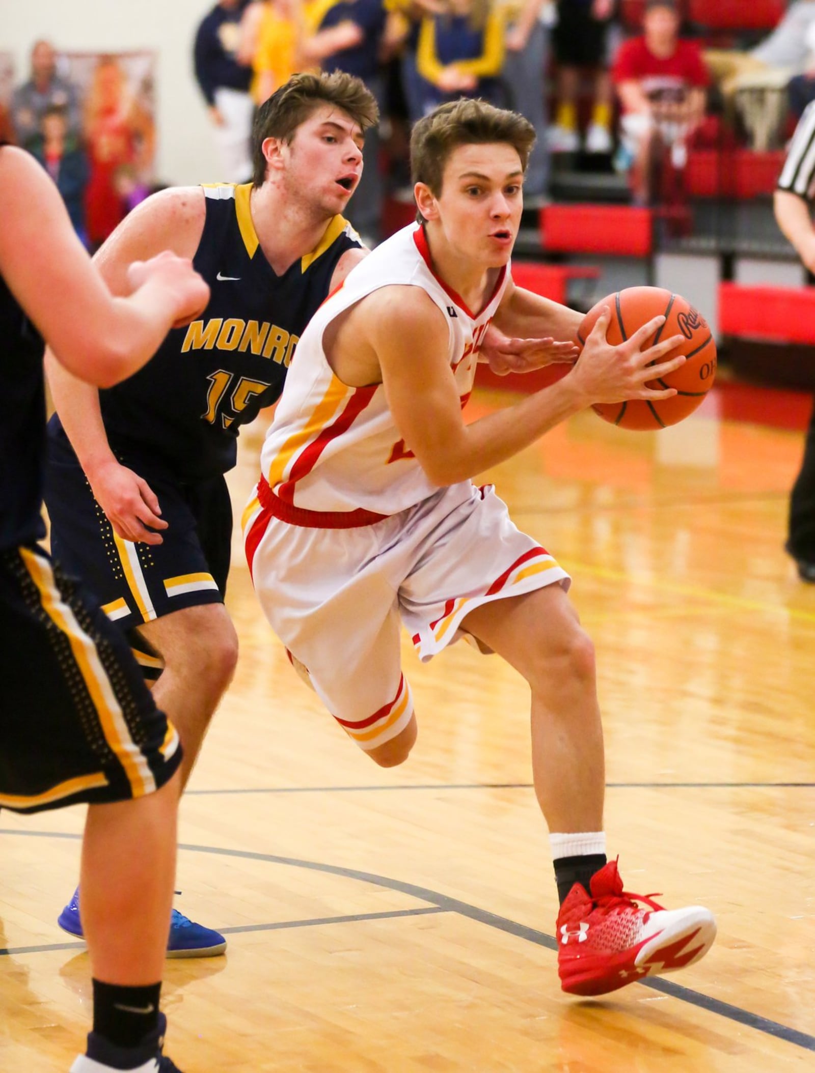 Fenwick guard David Luers (24) drives past Lawrence Puleo (15) of Monroe during Tuesday night’s game at Fenwick. GREG LYNCH/STAFF