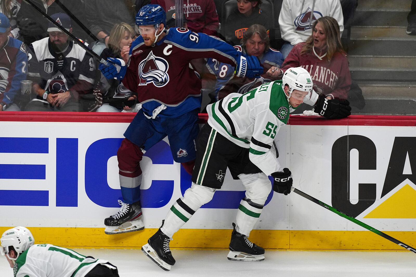Dallas Stars defenseman Thomas Harley, right, checks Colorado Avalanche left wing Gabriel Landeskog in the first period of Game 3 of an NHL hockey first-round playoff series Wednesday, April 23, 2025, in Denver. (AP Photo/David Zalubowski)