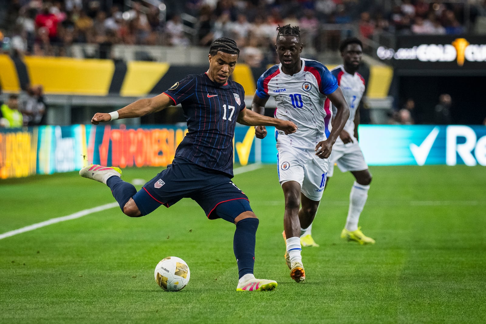 United States forward Malik Tillman (17) crosses the ball during a CONCACAF Gold Cup soccer match against Haiti, Sunday, June 22, 2025, in Arlington, Texas. (AP Photo/Jessica Tobias)