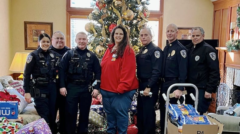 The Fairfield Twp. Police Department purchased gifts for the 64 residents at Birchwood Care Center, a nursing facility in the township. From left are Detective Emma Edens, Sgt. John VandeRyt, Detective Nic Spalding, Walmart's Rachel Hucks, Chief Robert Chabali, Capt. Doug Lanier, and School Resource Officer Jeffrey McDaniel.
