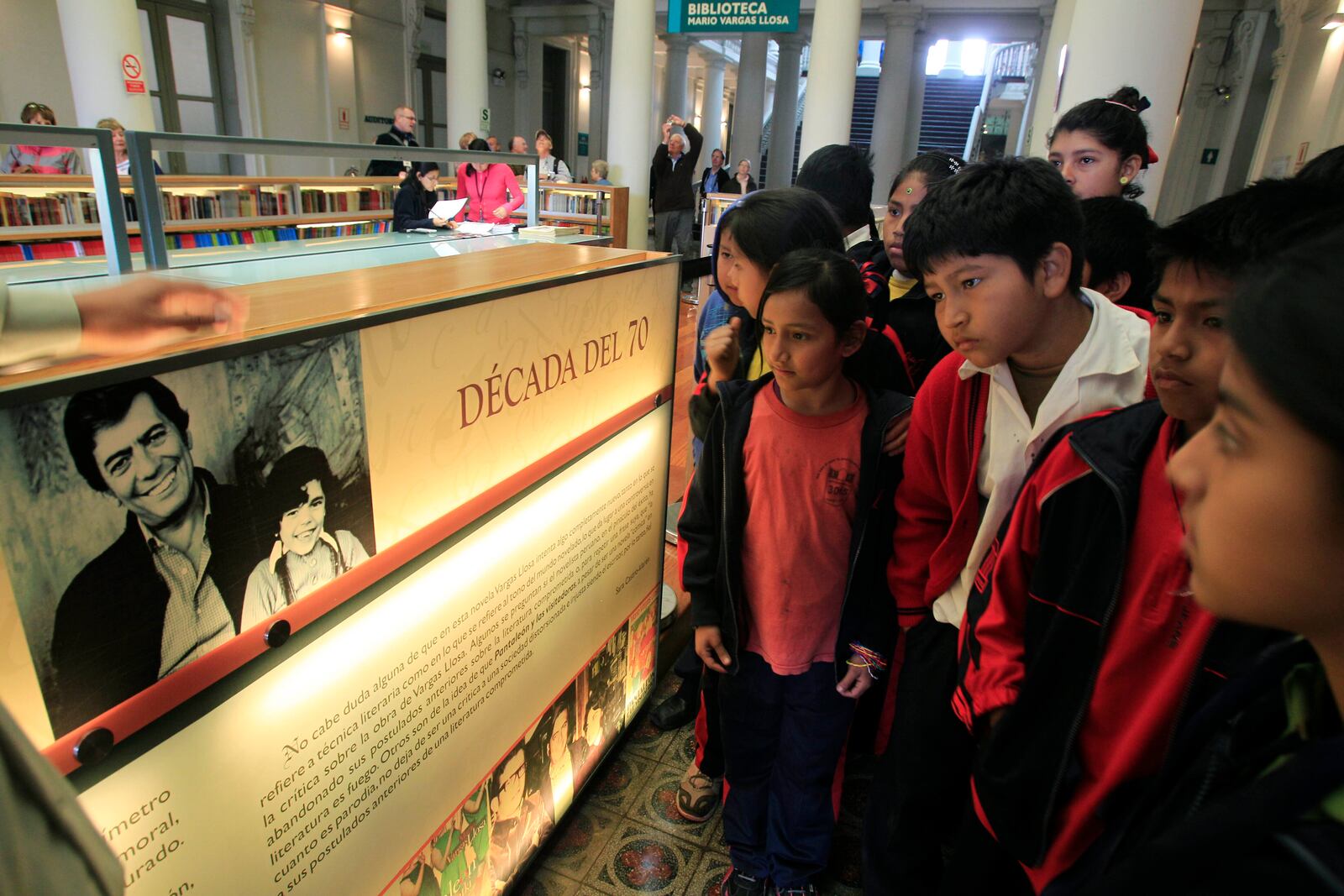 FILE - Students learn about Peruvian writer Mario Vargas Llosa at a public library in Lima, Peru, Oct. 7, 2010. (AP Photo/Martin Mejia, File)