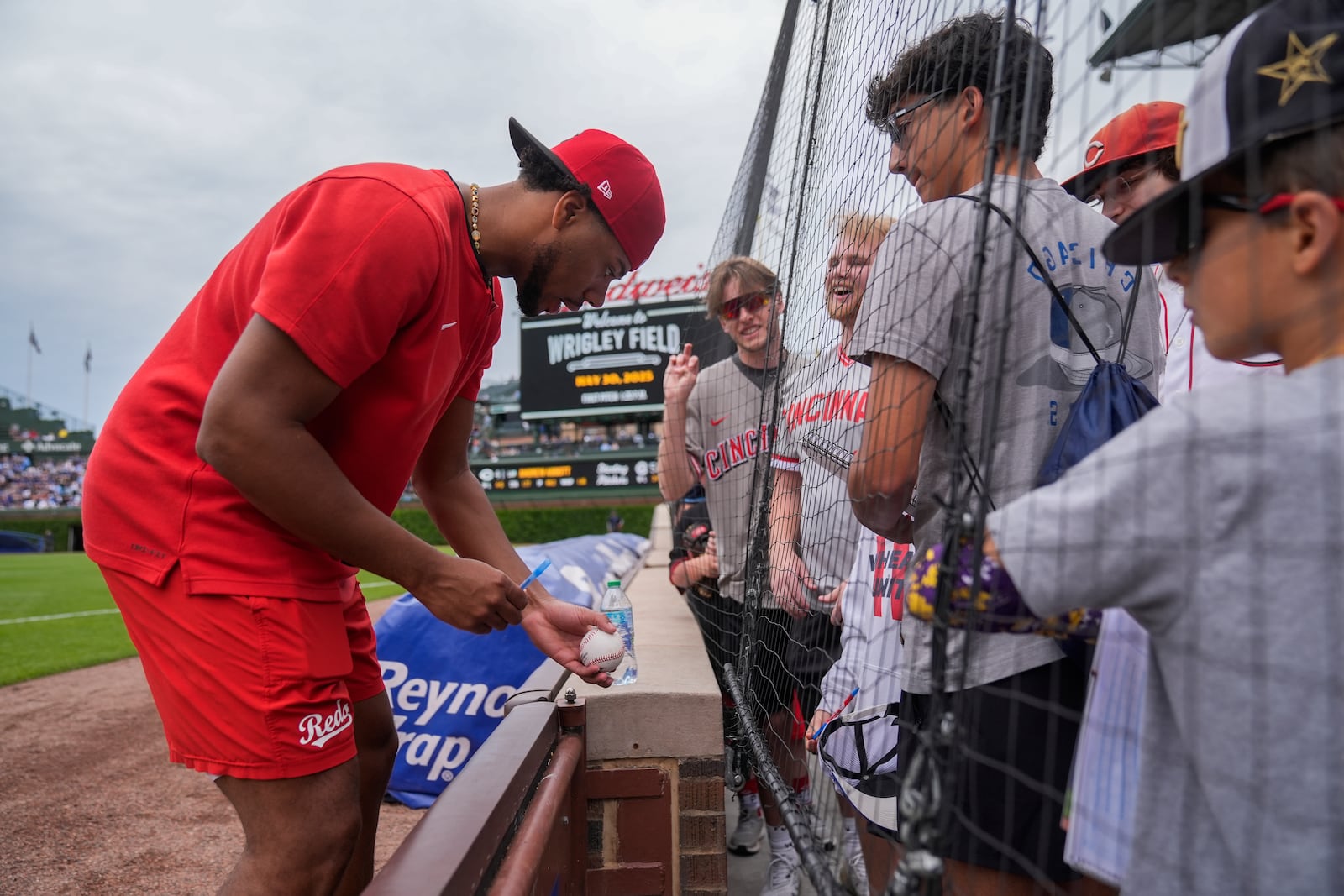 Cincinnati Reds pitcher Hunter Greene (21) signs autographs before a baseball game against the Chicago Cubs, Friday, May 30, 2025, in Chicago. (AP Photo/Erin Hooley)
