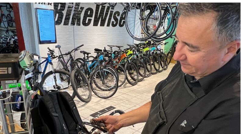 “I could get through these with a pair of side cutters in like 5 minutes,” BikeWise owner Doug Hamilton said as he handled a bike cable lock. JILLIAN INKS/OXFORD OBSERVER