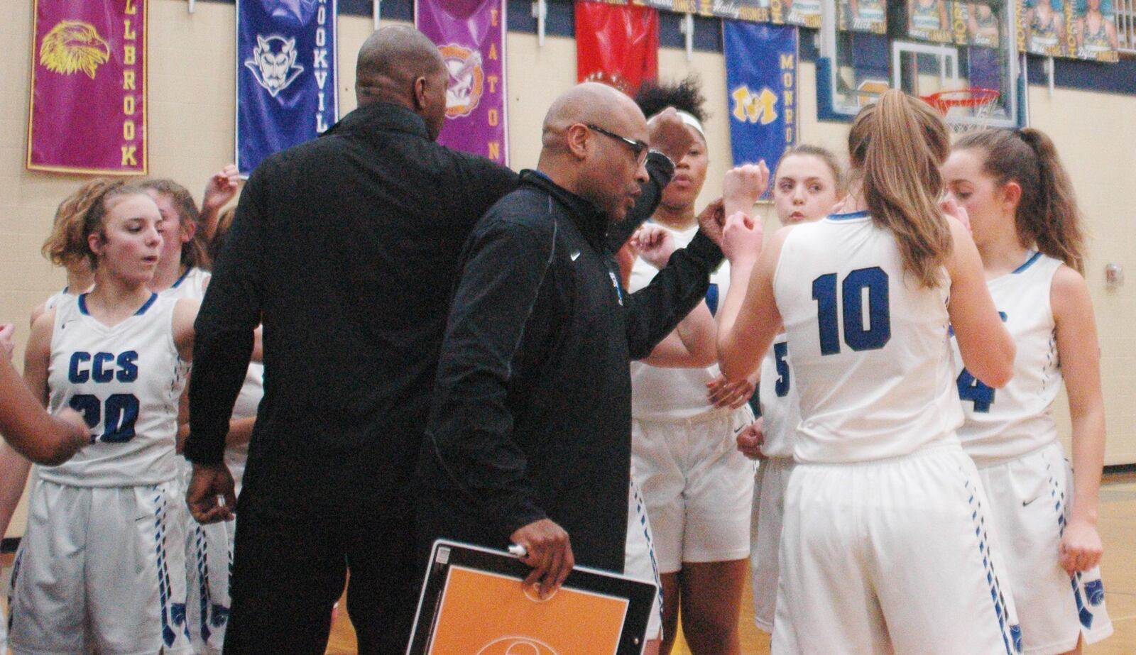 Cincinnati Christian coach Terrence Mitchell (wearing glasses) huddles with his team during Wednesday night’s Division IV sectional game at Monroe. CCS lost to South Charleston Southeastern 40-12. RICK CASSANO/STAFF