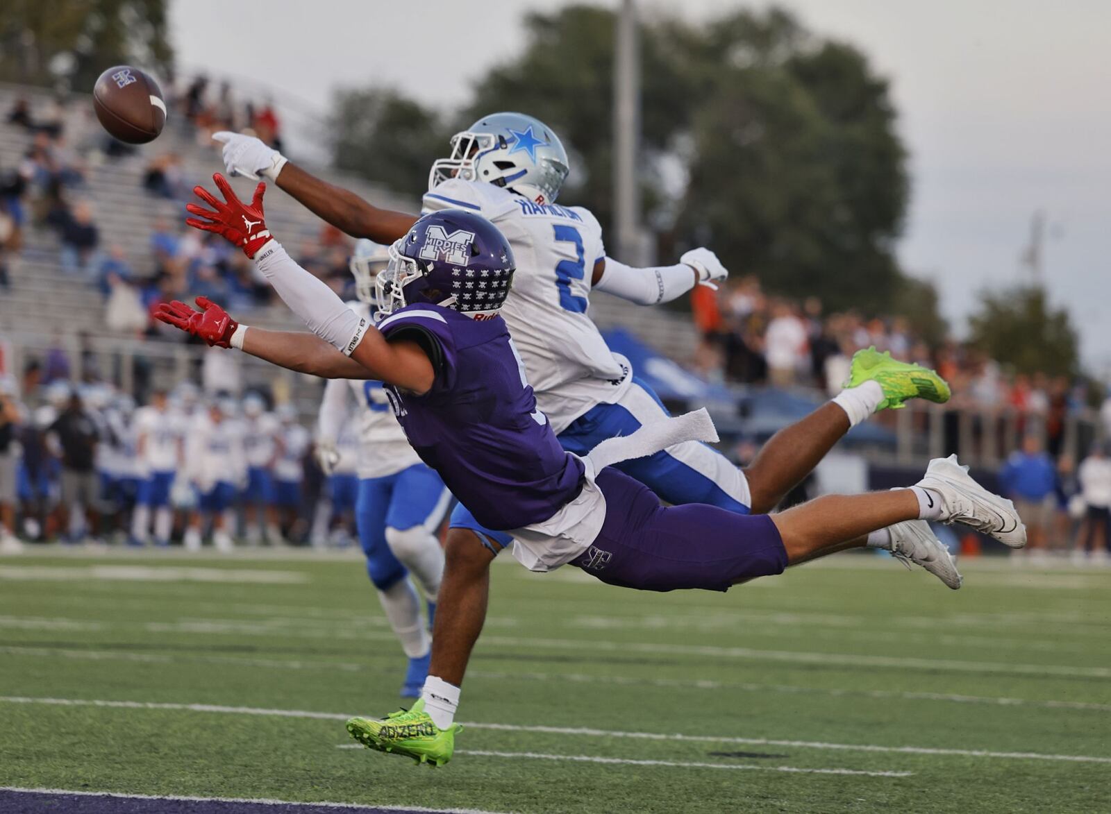 Middletown's Talan Malicote dives for a pass defended by Hamilton's Carter Isaacs during their football game Friday, Sept. 29, 2013 at Middletown's Chris Carter Field at Barnitz Stadium. Hamilton won 18-14. NICK GRAHAM/STAFF