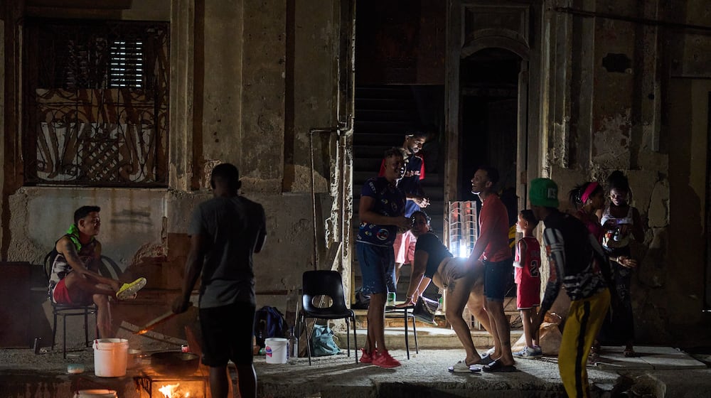 A man prepares caldosa, a traditional soup, during a birthday celebration on the street in Havana, Thursday, March 5, 2026. (AP Photo/Ramon Espinosa)