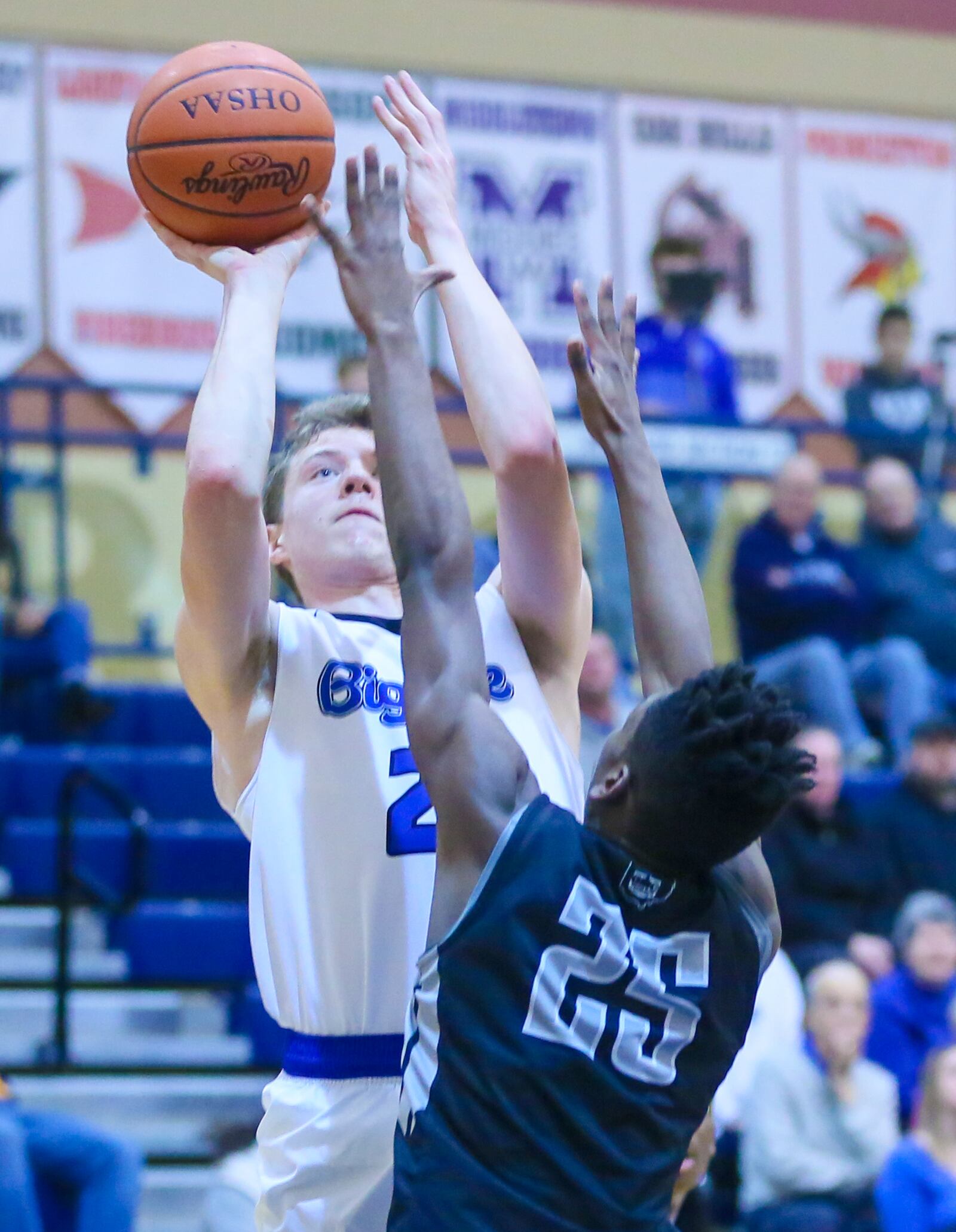Hamilton forward Hunter Hamilton (22) takes a shot over Lakota East’s Kyrell Metts (25) on Friday night at the Hamilton Athletic Center. GREG LYNCH/STAFF
