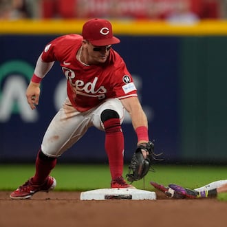 Cincinnati Reds second baseman Matt McLain, left, is late with the tag as Los Angeles Dodgers Miguel Rojas is safe at second base on a double during the fifth inning of a baseball game, Monday, July 28, 2025, in Cincinnati. (AP Photo/Carolyn Kaster)