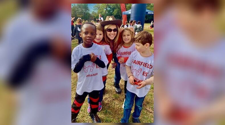 Fairfield West Elementary Principal Missy Mueller, pictured here with students, learned in June she had been stricken with myelodysplastic syndrome (MDS), which is a rare group of disorders in which your body no longer makes enough healthy blood cells. She decided to go public and campaign for all those battling illnesses who need donors to survive. (Provided Photo\Journal-News)