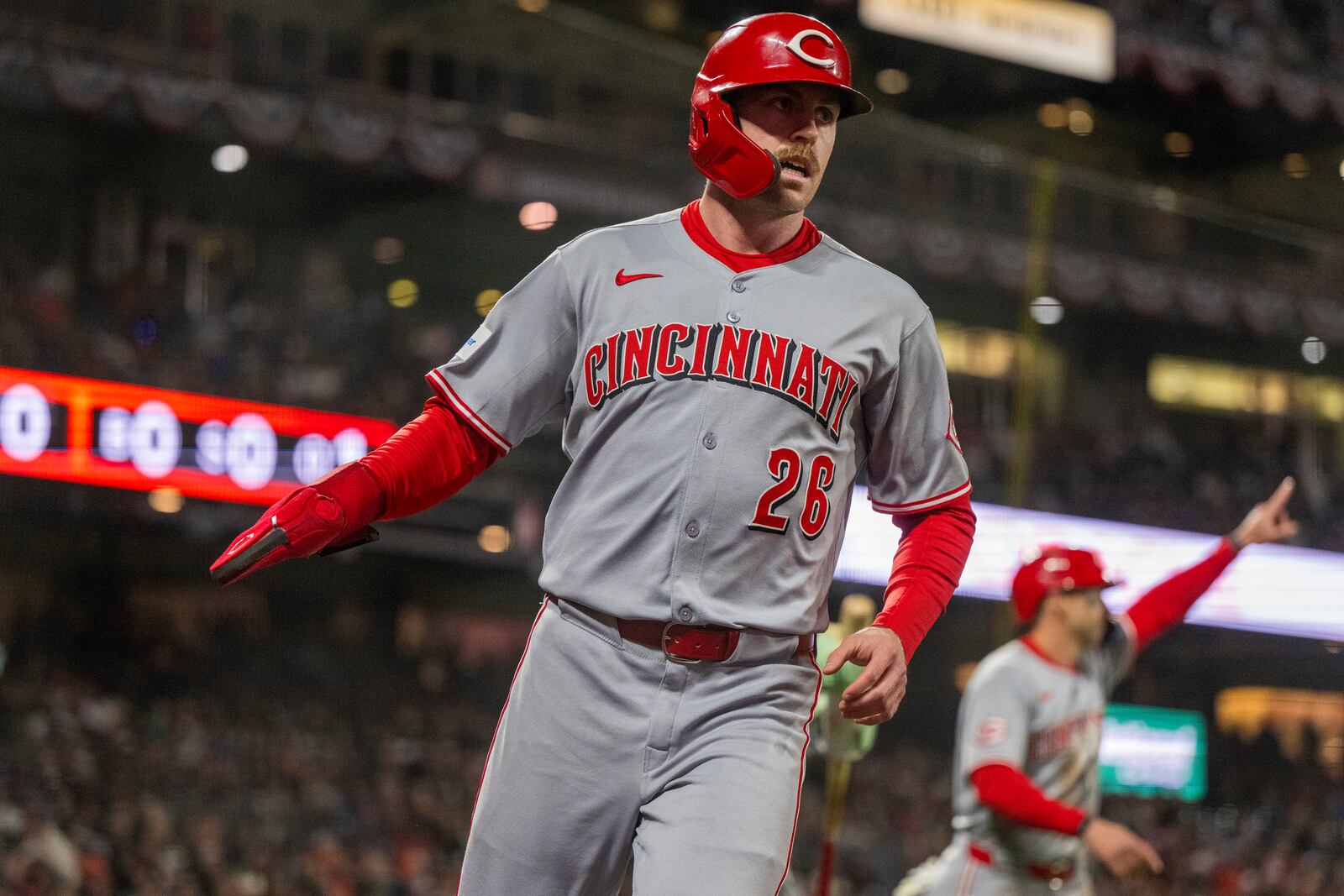 Cincinnati Reds' Jacob Hurtubise (26) scores during the eighth inning of a baseball game against the San Francisco Giants in San Francisco, Monday, April 7, 2025. (AP Photo/Nic Coury)