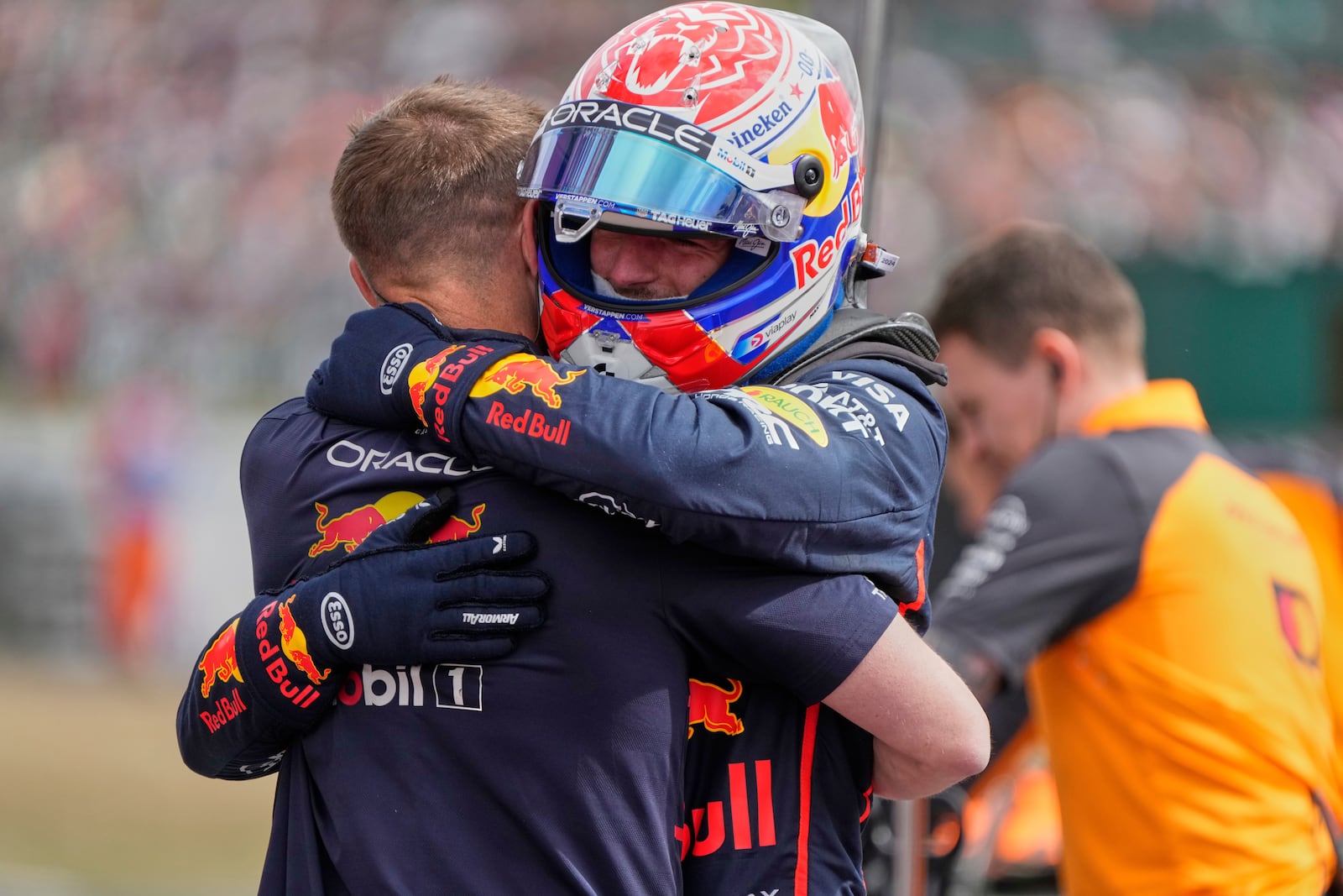 Red Bull driver Max Verstappen of the Netherlands hugs a team memebr after taking the pole position during the qualifying for the British Formula One Grand Prix in Silverstone, England, Saturday, July 5, 2025. (AP Photo/Darko Bandic)