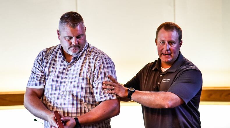Ken Henderson, Pastor of Quest Church, left, helps Middletown Division of Police Major David Birk, right, with a demonstration during an active shooter/awareness training class put on by Middletown Police Monday, August 12 in Middletown city council chambers. NICK GRAHAM/STAFF
