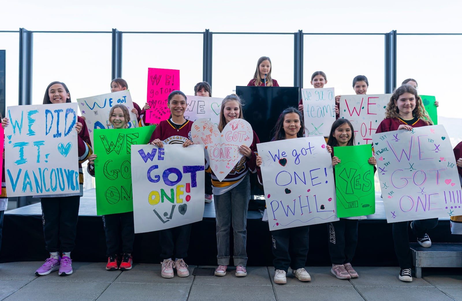Member of the Vancouver Angels girls ice hockey team help announce that the PWHL will be expanding to Vancouver for the 2025-26 season during a press event in Vancouver, British Columbia, Wednesday April 23, 2025. (Rich Lam/The Canadian Press via AP)