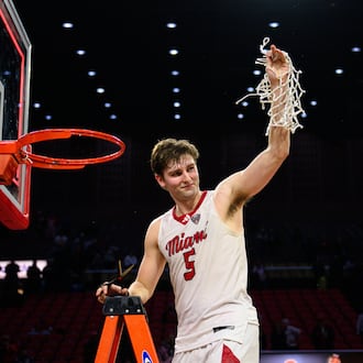 Miami University's Peter Suder raises the net towards the crowd in celebration after the RedHawks beat Toledo 74-72 in Mid-American Conference action on Tuesday, March 3, 2026 at Millett Hall. Miami clinched its first MAC regular season crown since the 2004-05 season. JEREMY MILLER / CONTRIBUTED PHOTO