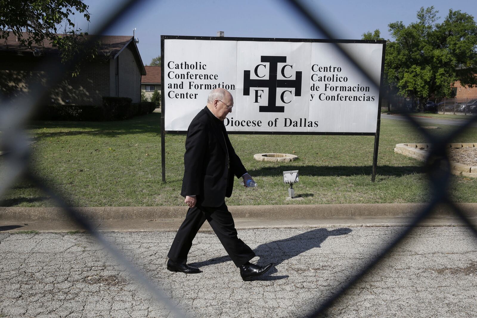 FILE - Catholic Bishop Kevin Farrell walks to speak to media outside the the Diocese of Dallas Catholic Conference and Formation Center on Oct. 20, 2014. (AP Photo/LM Otero, File)