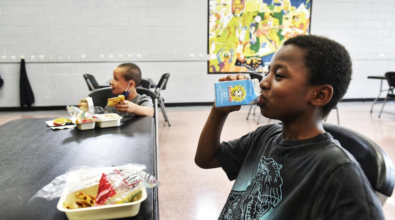 Don'Pierre Wilson, 9, right, and Jay Johnson, 6, eat a snack a t Booker T. Washington Community Center Wednesday, August 26, 2020 in Hamilton. NICK GRAHAM / STAFF