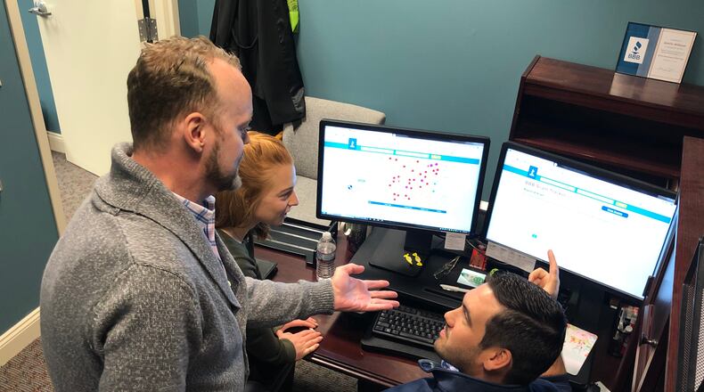 John North, Johanna Hartley and Brent Myers of the Miami Valley Better Business Bureau look at scams on the BBB Scam Tracker. Scams increase around the holidays as consumers spend more money. Ashlie Wilkson for the Dayton Daily News