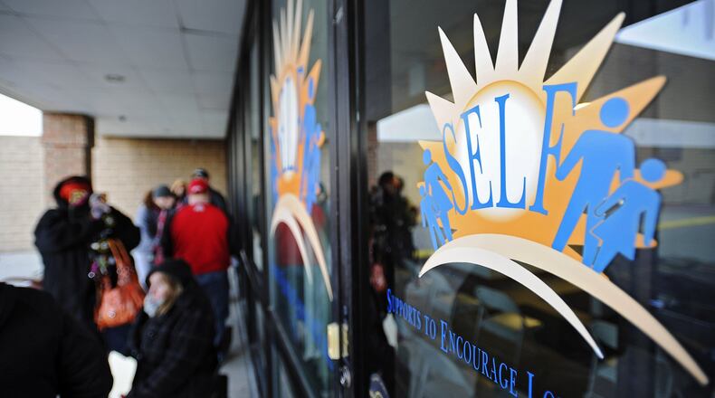People lined up Wednesday, Dec. 31, to apply for emergency heat assistance outside of the SELF (Supports to Encourage Low-Income Families) headquarters in Hamilton.