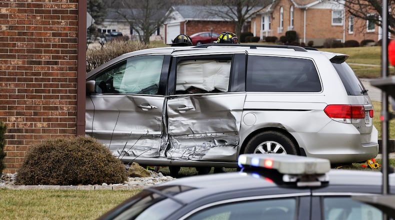 A van crashed into apartment at intersection of NW Washington Boulevard and Cleveland Avenue on Wednesday afternoon in Hamilton. One person in the van was transported to the hospital by ambulance. NICK GRAHAM/STAFF