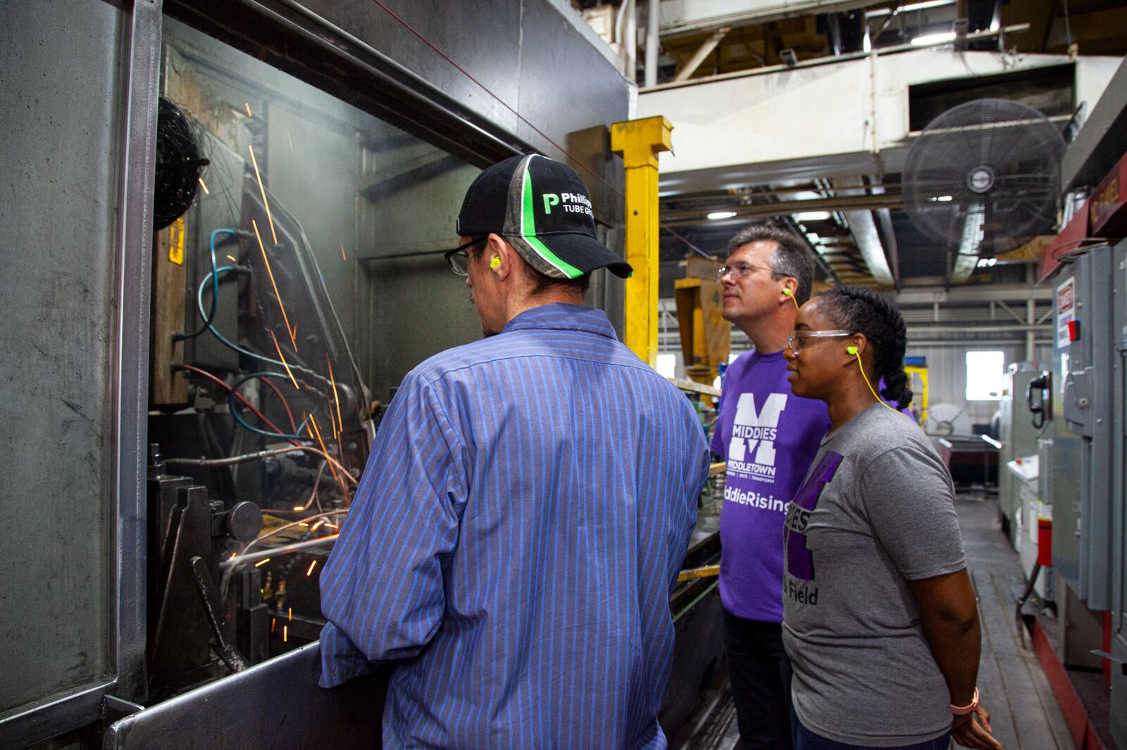 Middletown High School teachers Christa Wilson (right) and Jake Senft (middle) learn more about manufacturing steel tubing as part of a new program putting non-tech area teachers into local industries so they can better explain job and career options to their students. Butler Tech's new Manufacturing Educator Externship Team (MEET) program includes participating companies like Middletown-based Phillips Tube Group where they recently spent an eight-hour shift. (Provided Photo\Journal-News)
