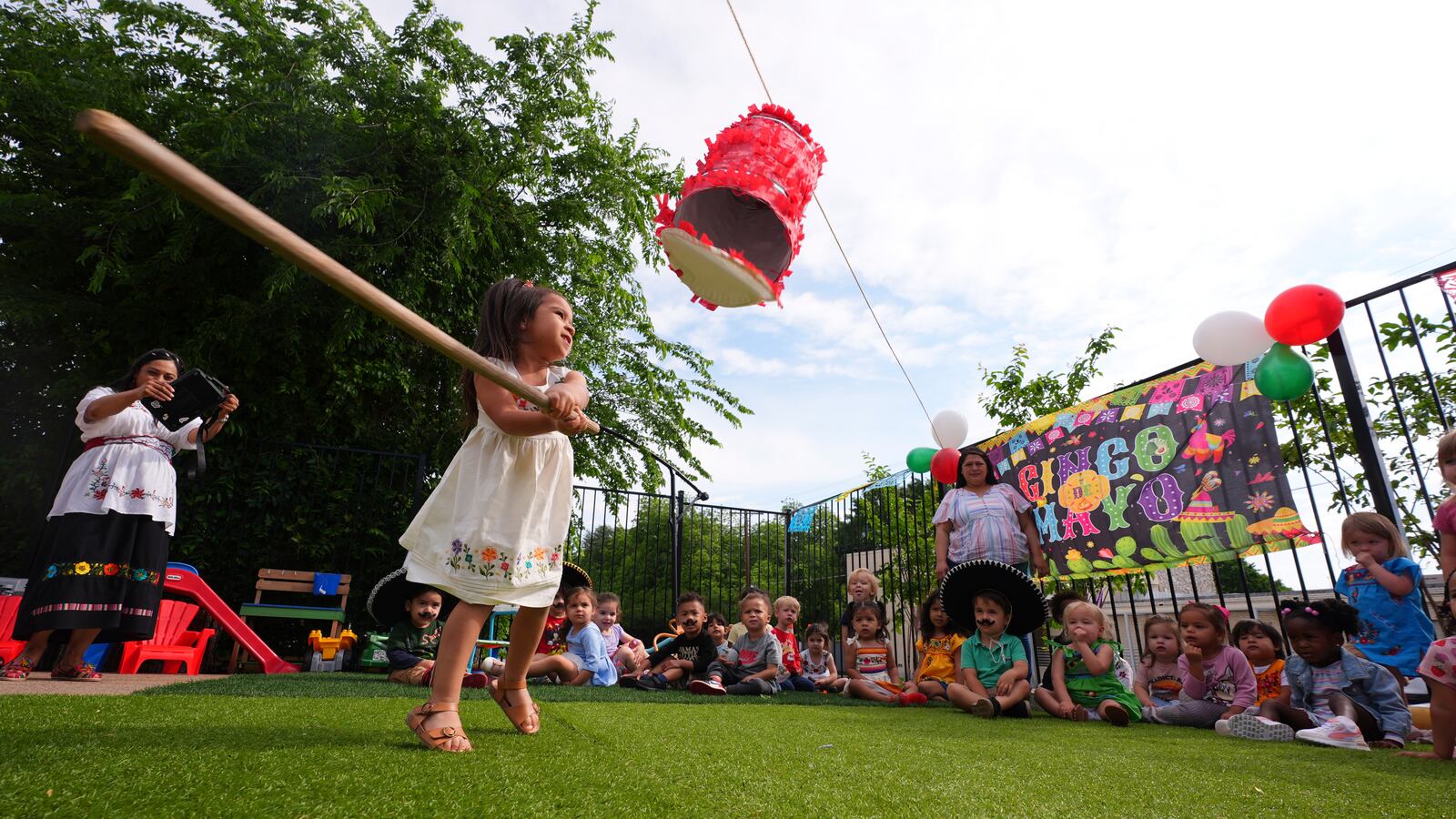 Victoria Jasso, 2, swings at a piñata during a Cinco de Mayo celebration at the Yorktown Spanish School in Dallas, Monday, May 5, 2025. (AP Photo/LM Otero)