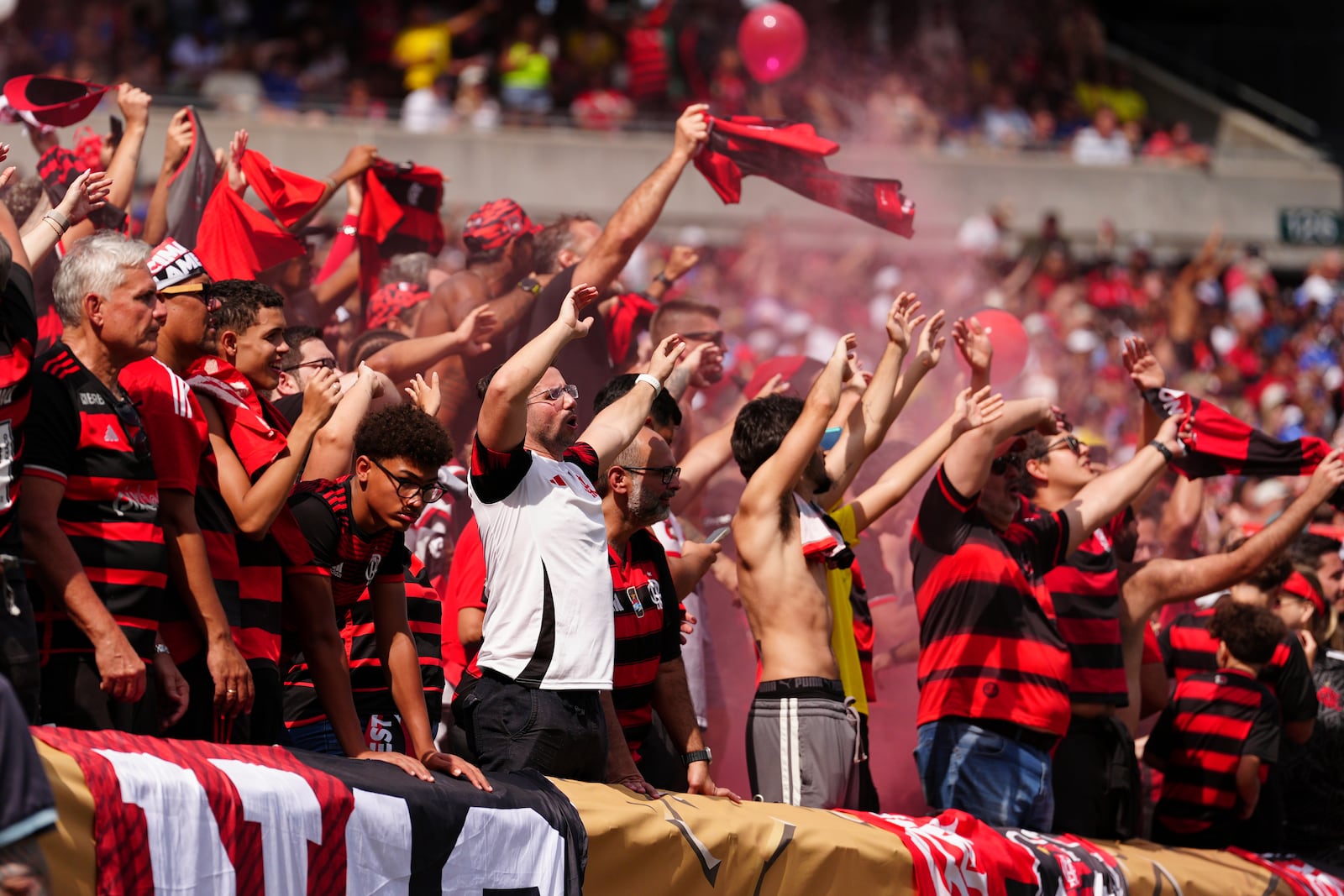Flamingo fans burn torches during the Club World Cup Group D soccer match between Flamengo and Chelsea in Philadelphia, Friday, June 20, 2025. (AP Photo/Derik Hamilton)