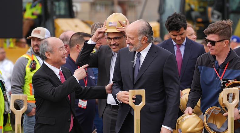 Masayoshi Son, Chairman and CEO of SoftBank Group Corp., left, and Howard Lutnick, Secretary of Commerce speak at a groundbreaking for a new data center Friday, March 20, 2026, in Piketon, Ohio. (AP Photo/Joshua A. Bickel)