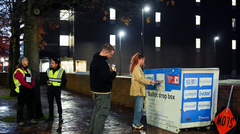 FILE - A voter poses for a photo as they place their ballot in a drop box on Election Day, Nov. 5, 2024, in Seattle. (AP Photo/Lindsey Wasson, File)