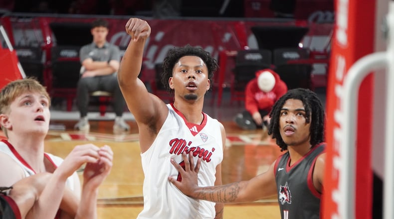 Miami’s Eian Elmer puts up a free throw and is boxed out by Indiana University East’s Jeremiah Landers during their game on Tuesday night at Millett Hall. CHRIS VOGT / CONTRIBUTING