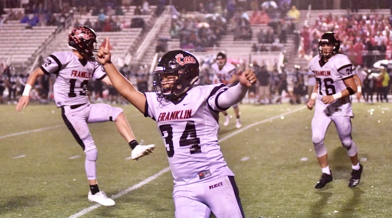 Franklin players celebrate a victory at Valley View on Friday night. Nick Graham/STAFF