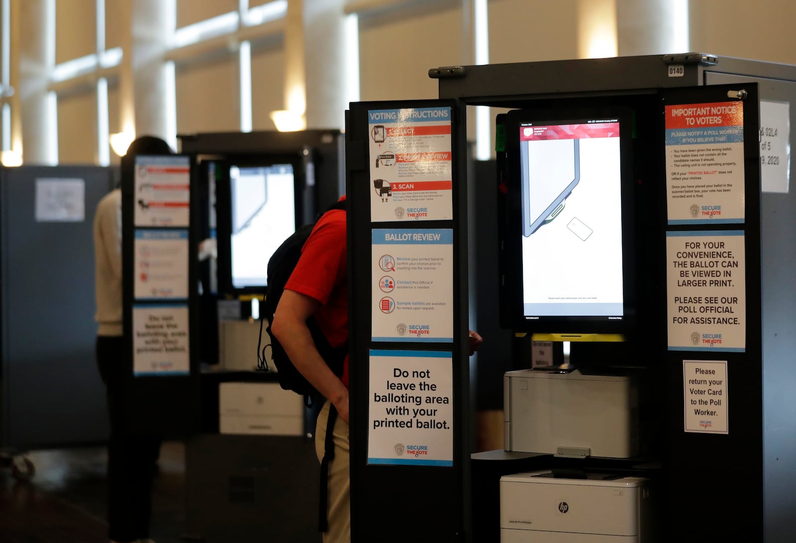 FILE - People vote at voting booths in the Georgia's primary election at Park Tavern June 9, 2020, in Atlanta. (AP Photo/Brynn Anderson, File)