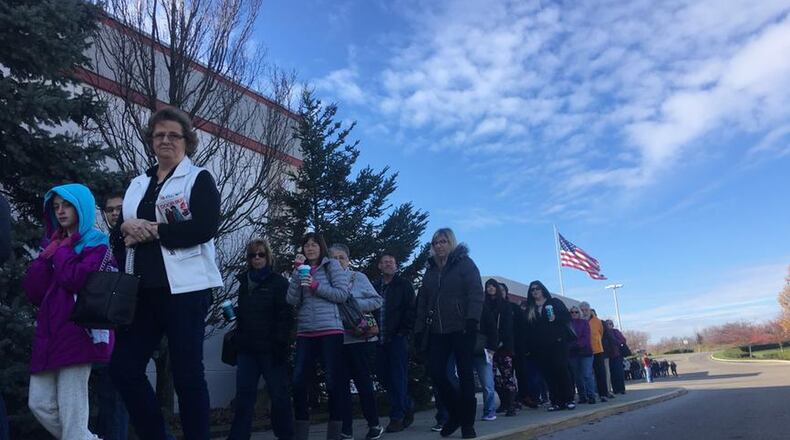 Shoppers line up outside of Elder-Beerman at the Dayton Mall on Thanksgiving last year. Millions are expected to shop during the Thanksgiving through Cyber Monday weekend again this year. KARA DRISCOLL/STAFF
