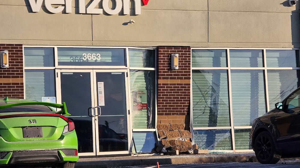 A car ran into the front of the Verizon store at 3663 Towne Blvd. Friday on the east side of Middletown. NICK GRAHAM/STAFF