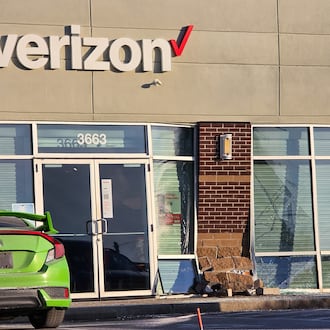 A car ran into the front of the Verizon store at 3663 Towne Blvd. Friday on the east side of Middletown. NICK GRAHAM/STAFF