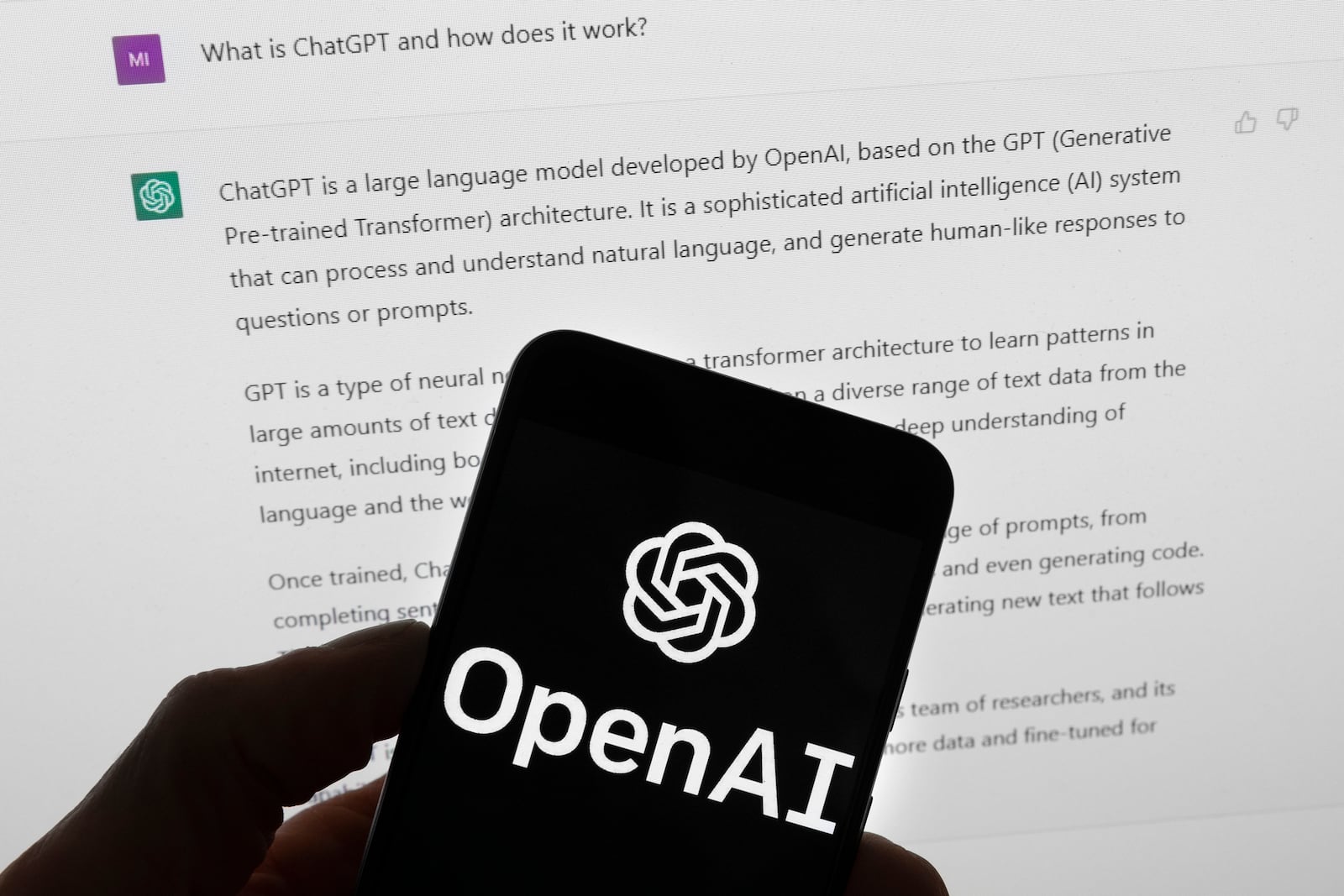 FILE - The OpenAI logo is seen on a mobile phone in front of a computer screen which displays output from ChatGPT, March 21, 2023, in Boston. (AP Photo/Michael Dwyer, File)