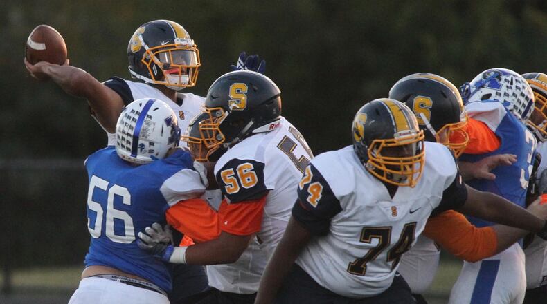 Springfield's Leonard Taylor throws a pass against Xenia on Friday, Sept. 29, 2017, at Xenia. David Jablonski/Staff