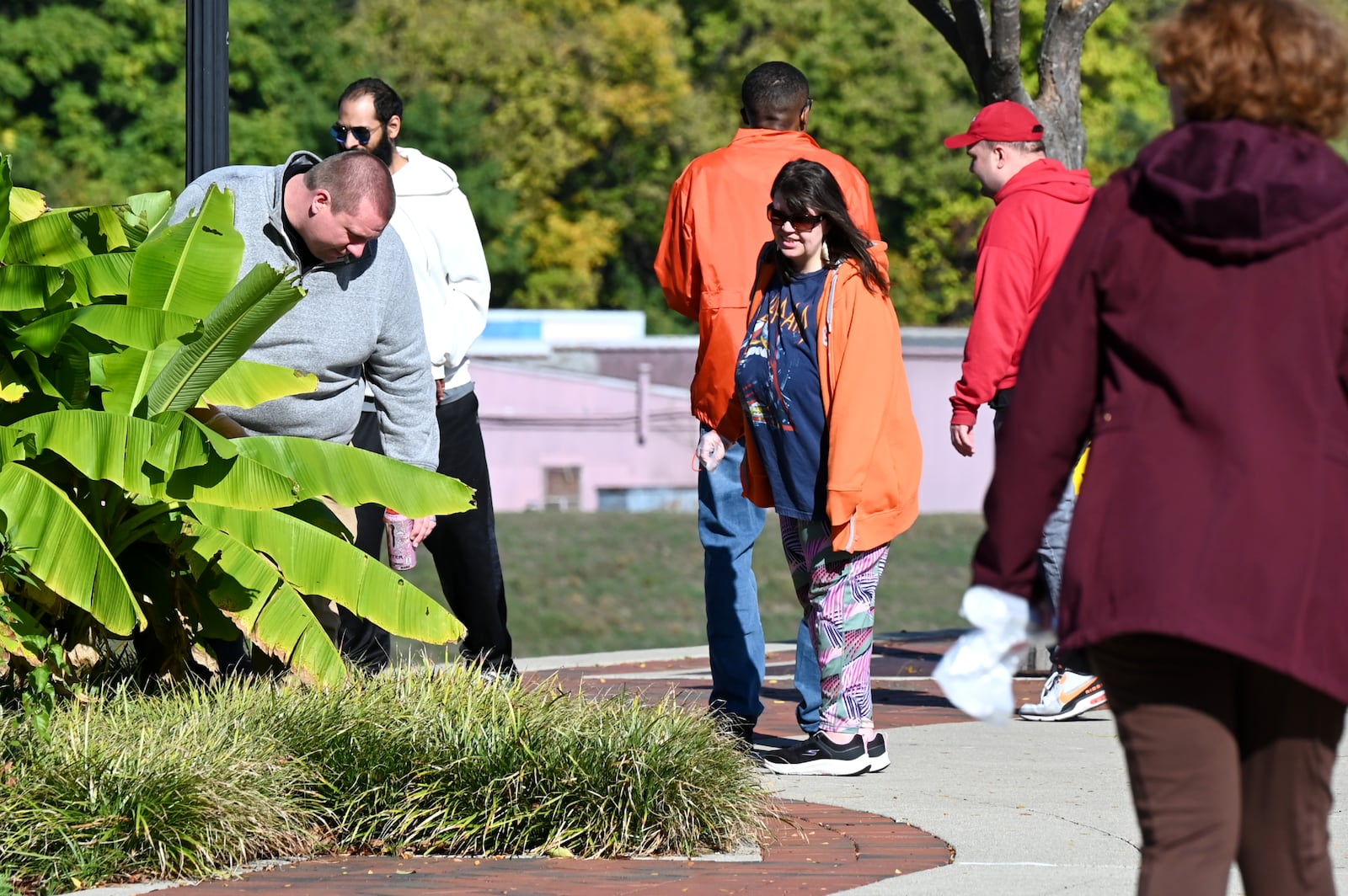 The Hamilton Parks Conservancy District initiated a pilot Adopt-a-Park program this year with Inspiration Studios and is rolling it out to the community, inviting organizations and businesses to adopt any one of the city's 42 park properties. Pictured is Inspiration Studios Director of Operations Colton Mehlman helping clean up an area of Marcum Park on Thursday morning, Oct. 23, 2025. The organization has agreed to clean up parks around its downtown Hamilton location. MICHAEL D. PITMAN/STAFF