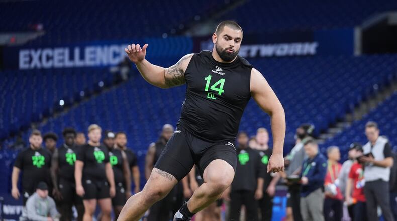 Georgia offensive lineman Dylan Fairchild runs a drill at the NFL football scouting combine in Indianapolis, Sunday, March 2, 2025. (AP Photo/Michael Conroy)
