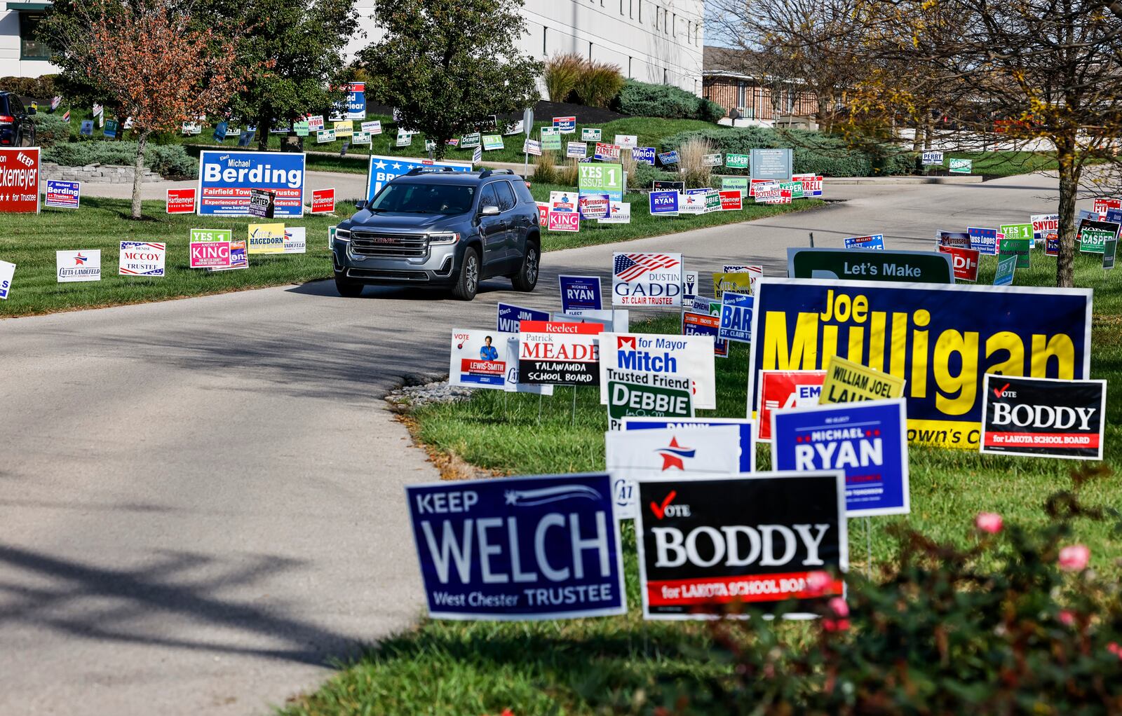 Political signs line the entrance for early voting Monday, Nov. 1, 2021, at the Butler County Board of Elections in Hamilton. NICK GRAHAM/STAFF