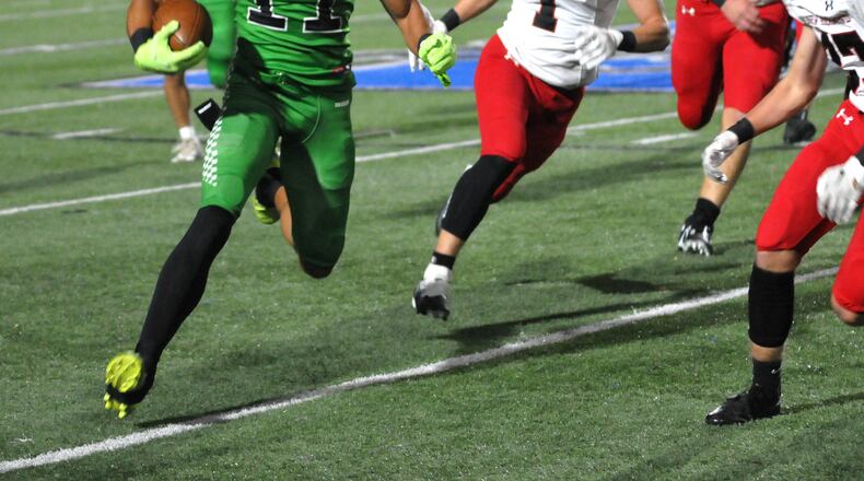 Badin's Braedyn Moore, attempts to get around the New Richmond defense during the first quarter of a Division III playoff game at Hamilton High School on Friday, Nov. 4. DAVID A. MOODIE/CONTRIBUTING PHOTOGRAPHER