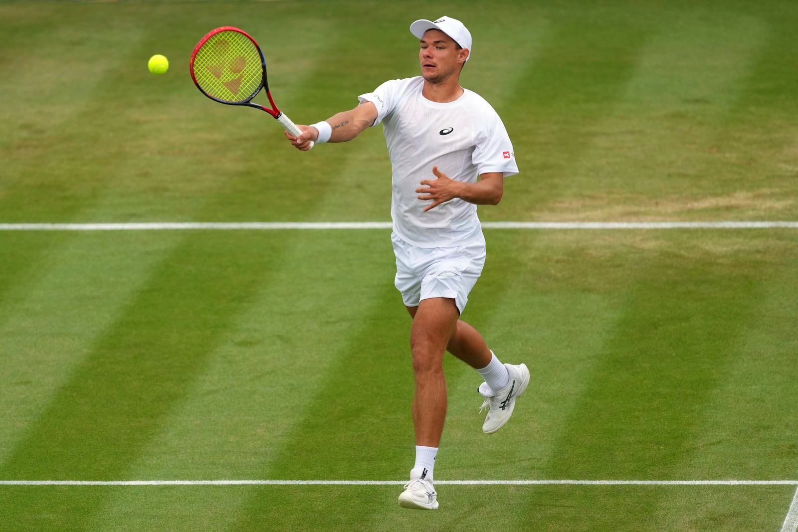 Kamil Majchrzak of Poland plays a return to Karen Khachanov of Russia during their men's singles fourth round match at the Wimbledon Tennis Championships in London, Sunday, July 6, 2025.(AP Photo/Kirsty Wigglesworth)