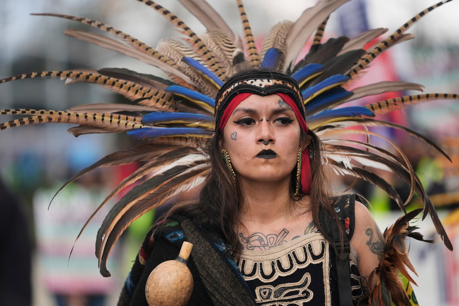 Jasmine Flores wears indigenous Mexican clothing as she and thousands of people march in a May Day rally and protest Thursday, May 1, 2025, in Chicago. (AP Photo/Erin Hooley)