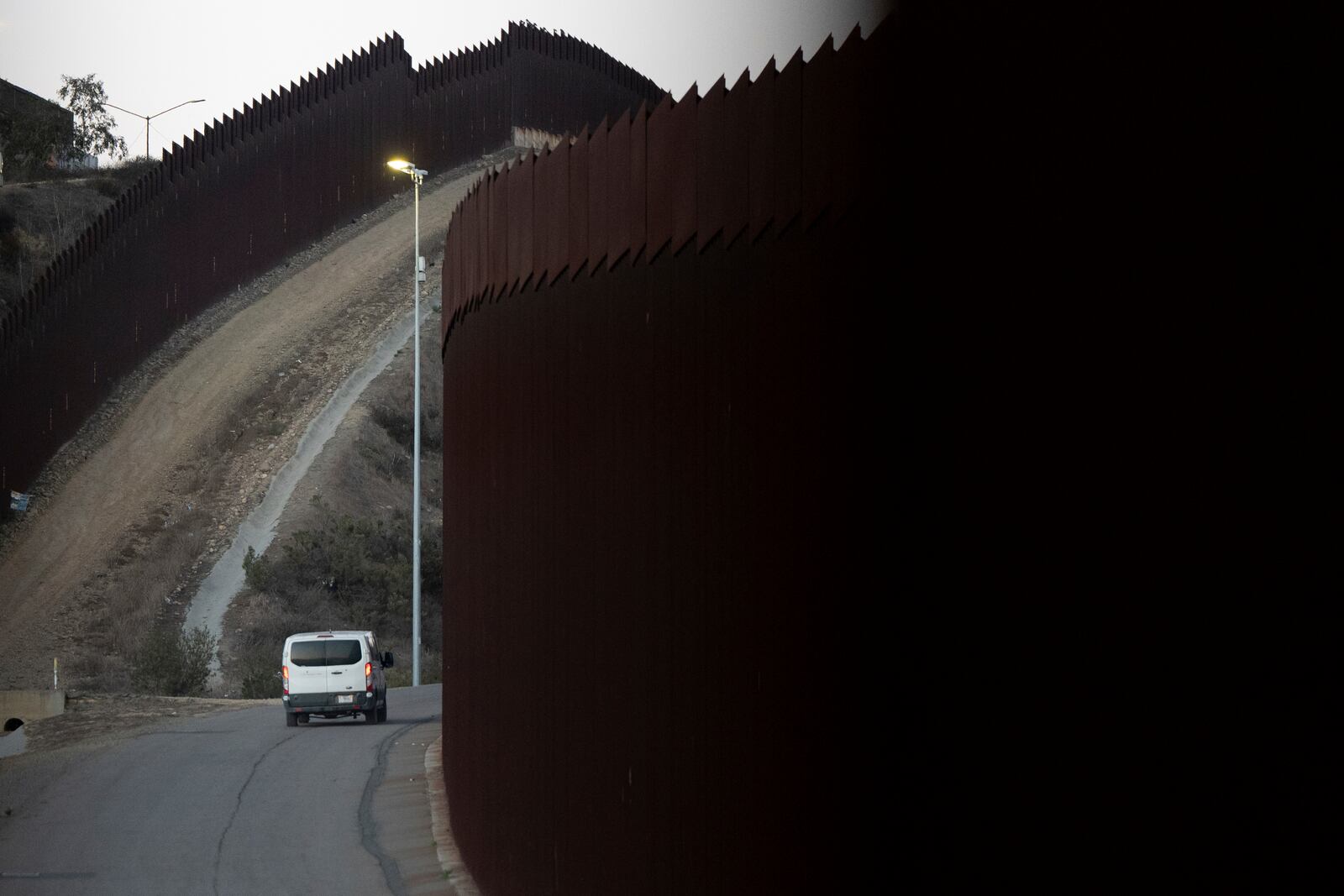 FILE— A Border Patrol van transports a group of migrants, Jan. 21, 2025, after they crossed illegally between two border walls separating Mexico and the United States in San Diego, Texas. (AP Photo/Gregory Bull, File)
