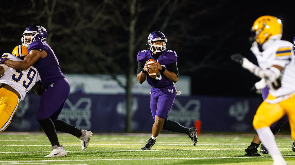 Middletown High School quarterback Joseph Ward rolls out to pass during their game against Springfield on Friday, Nov. 14 at Barnitz Stadium. The Middies won 14-0 to advance to their first regional final since 1990. NICK GRAHAM / STAFF PHOTO