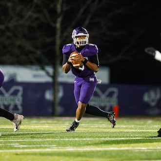 Middletown High School quarterback Joseph Ward rolls out to pass during their game against Springfield on Friday, Nov. 14 at Barnitz Stadium. The Middies won 14-0 to advance to their first regional final since 1990. NICK GRAHAM / STAFF PHOTO