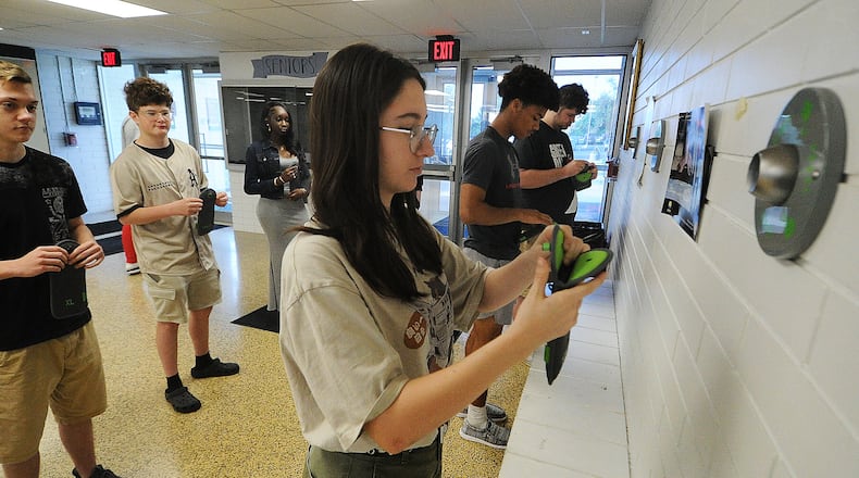 Fairborn High School students place their cell phones into pouches Thursday, May 23, 2024. Front row, left to right, Isabelle Fischer, Andrew Wilson and Travis Butts, back row from left Shane Walden, Clayton Finlay and Aita Samb. MARSHALL GORBY\STAFF