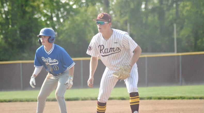 Hamilton base runner Nick Brosius and Ross first baseman Nathan Bray eye a pitch at the plate during their Division I sectional game on Wednesday. Big Blue won 1-0 in eight innings. Chris Vogt/CONTRIBUTED
